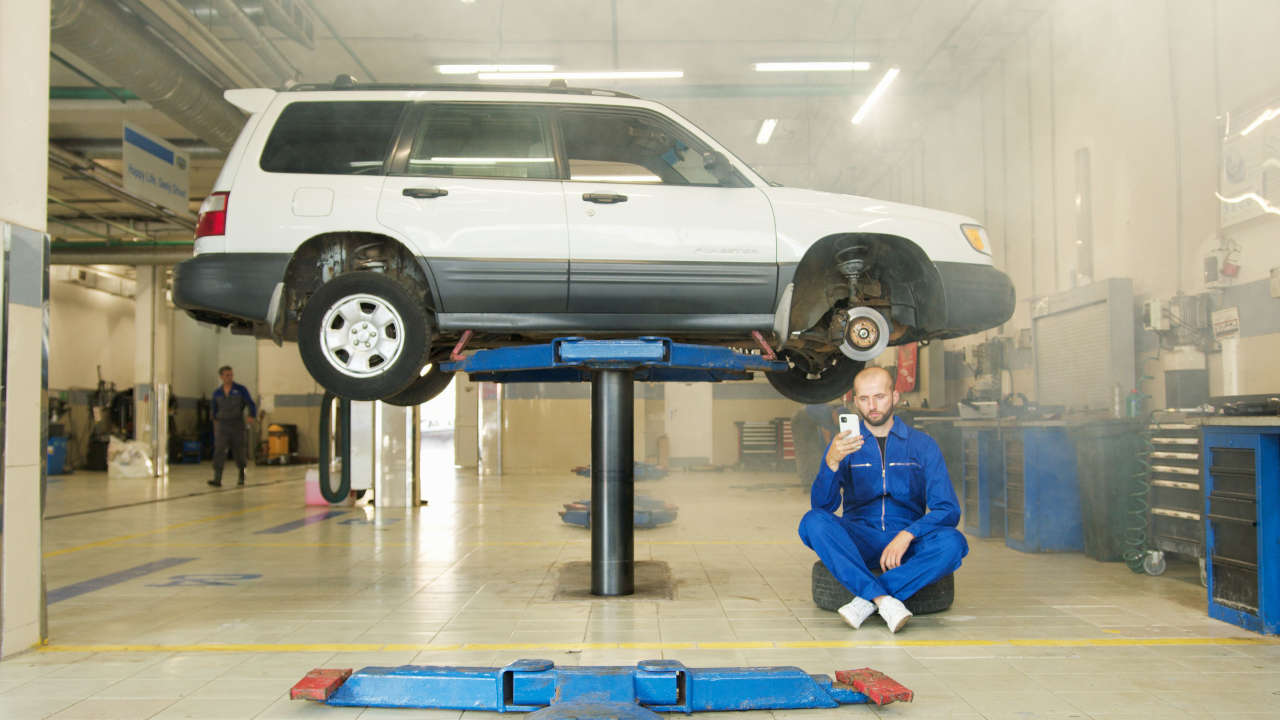 Mechanic using a professional LAUNCH diagnostic scanner while diagnosing a vehicle