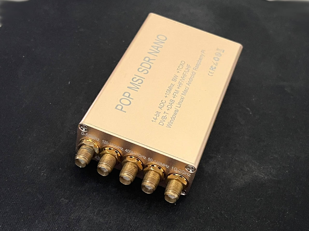 MSI.SDR NANO wideband software-defined radio receiver in a gold aluminum enclosure with five SMA antenna connectors.