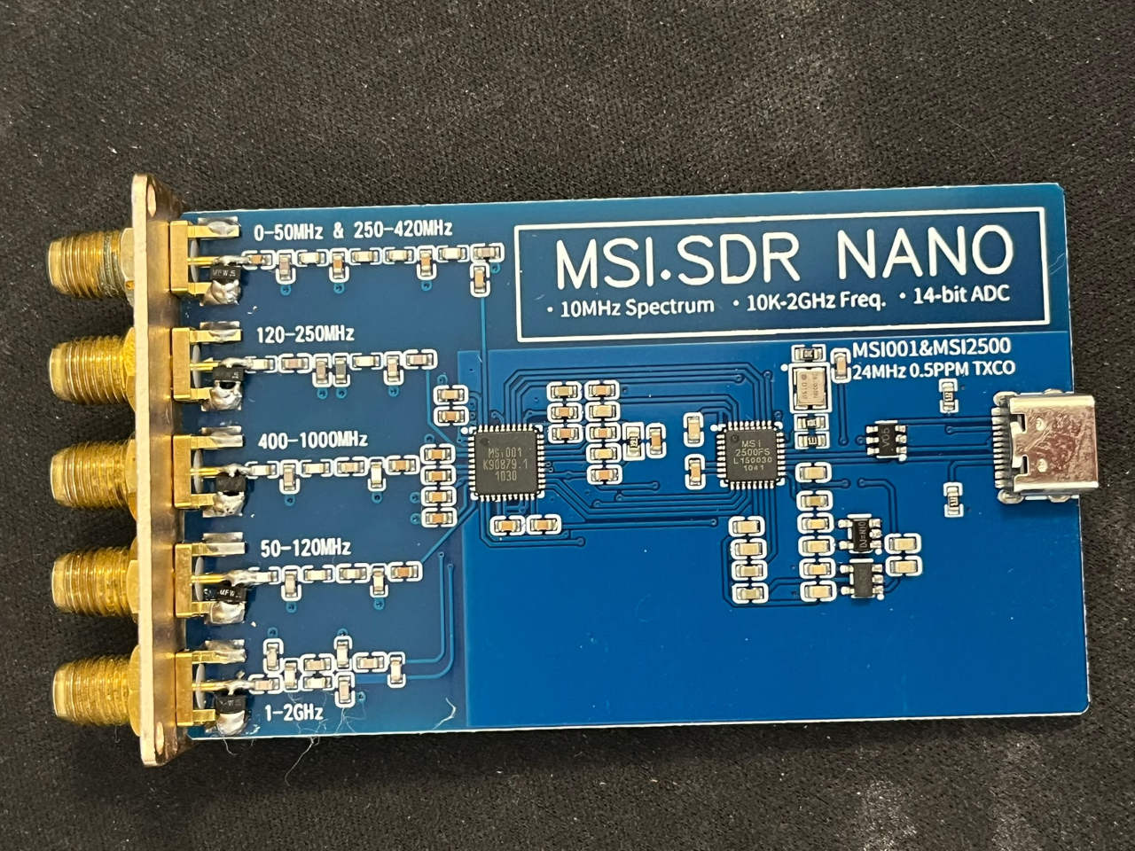 MSI.SDR NANO wideband software-defined radio receiver in a gold aluminum enclosure with five SMA antenna connectors. Inside view.