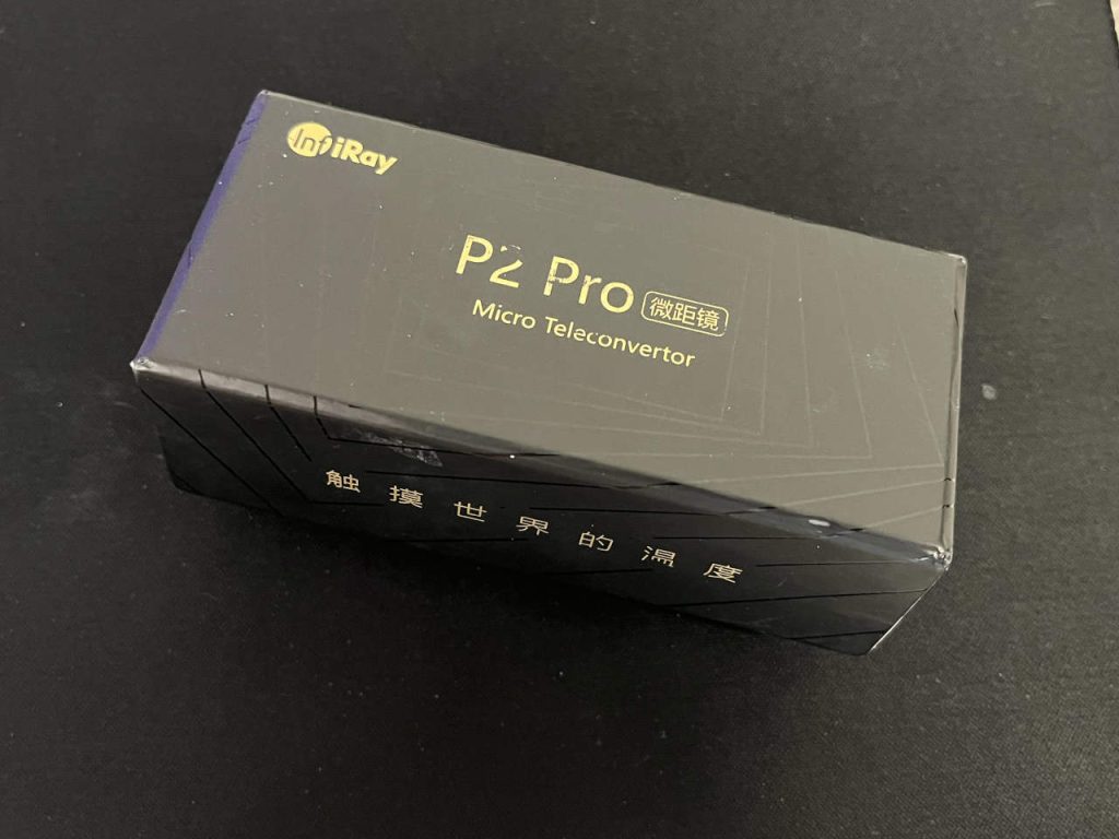 InfiRay P2 Pro USB-C thermal camera with magnetic macro lens on a dark surface.