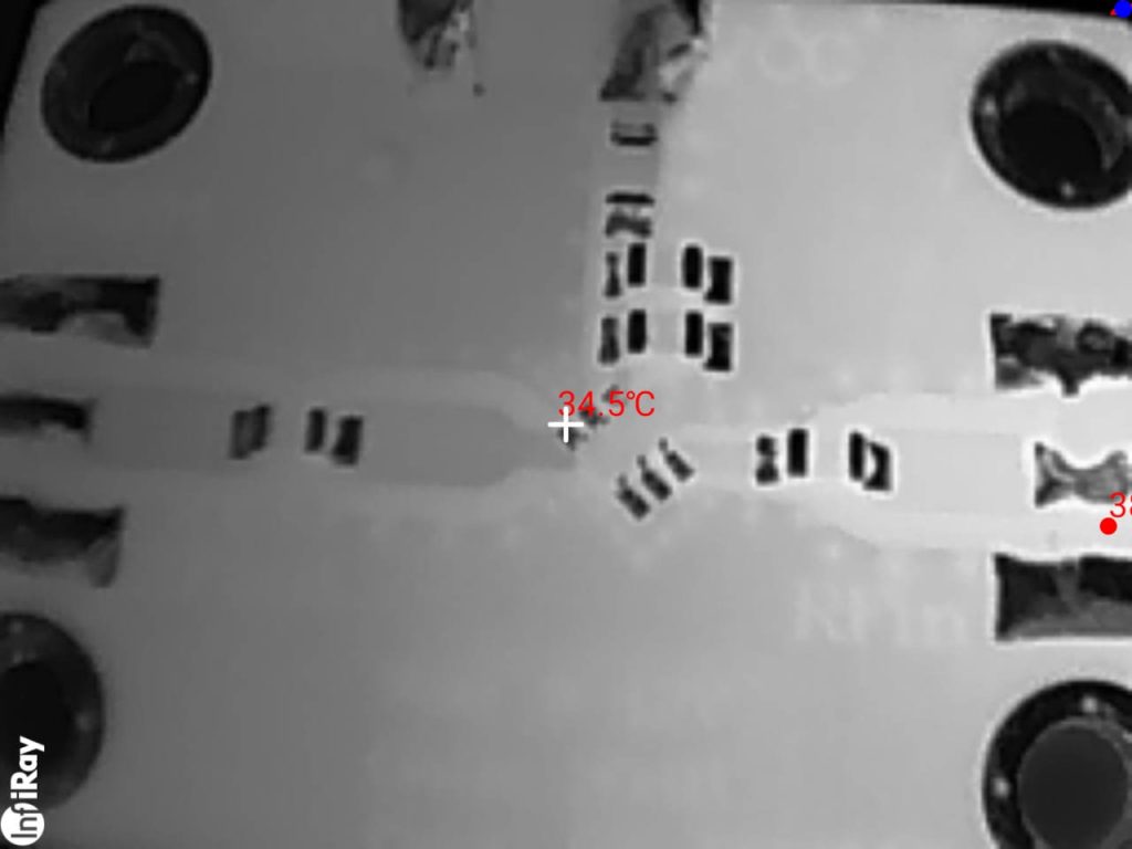 Close-up thermal image of SMD electronic components on a circuit board captured with the InfiRay P2 Pro.