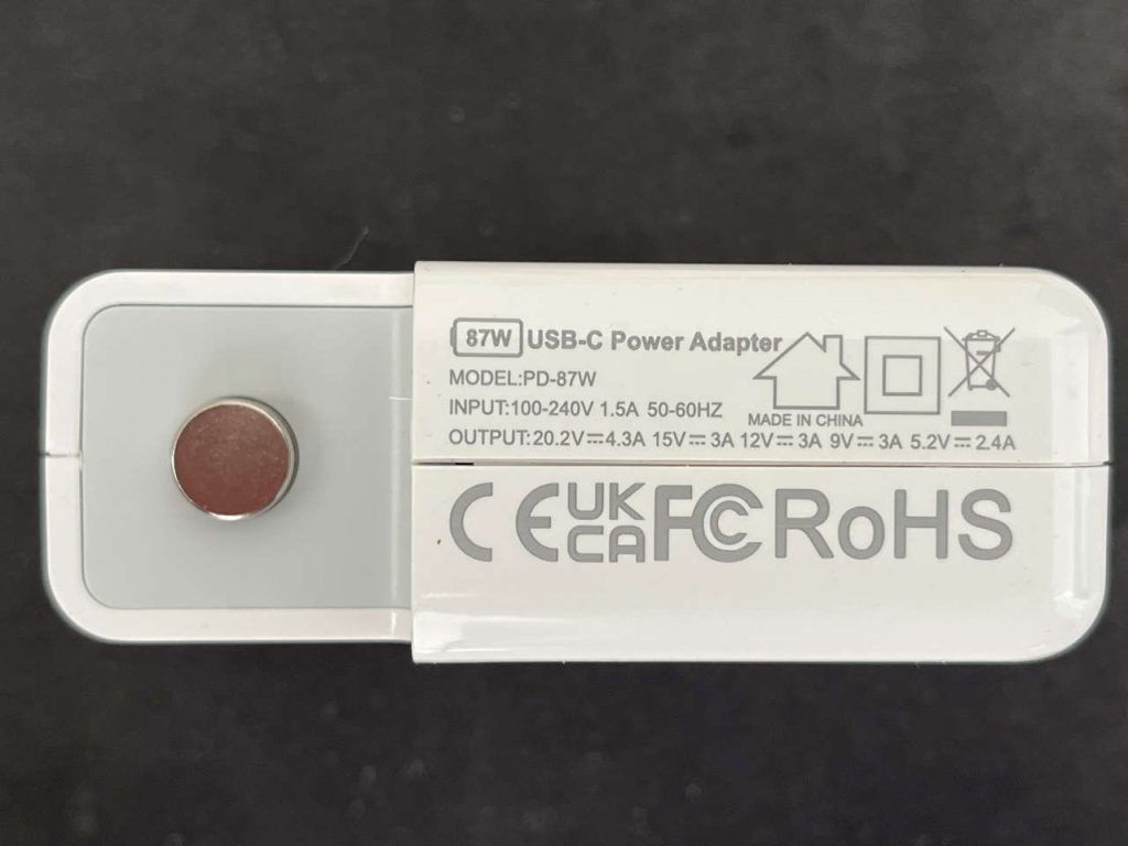 Label on a PD-87W USB-C power adapter showing 87W rating and multiple output voltages.