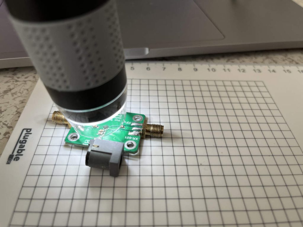 Plugable USB microscope inspecting electronic components on an XR-601 circuit board.