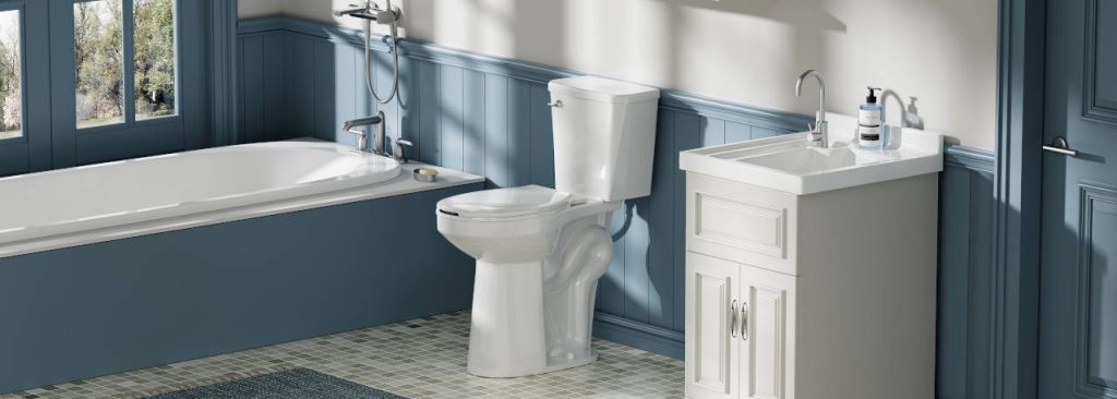 Modern bathroom with a white toilet, compact vanity sink, bathtub, blue paneled walls, and gray tiled flooring.